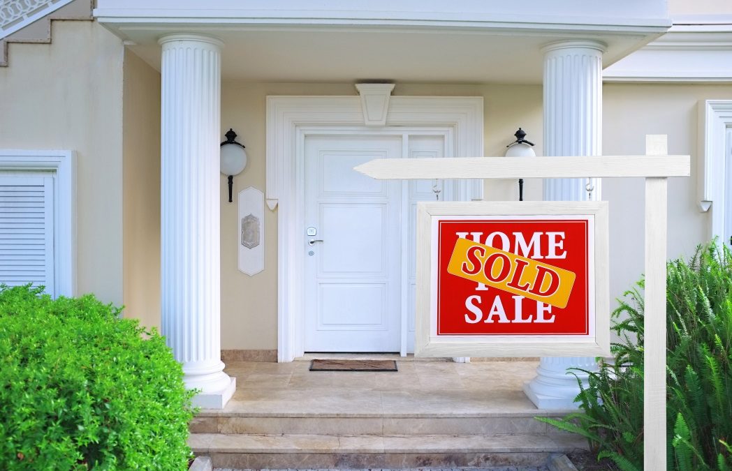 Sold home for sale Real estate sign in front of new house