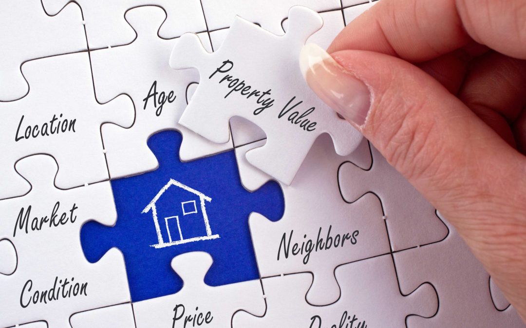 Property Value – female hand with real estate concept puzzle