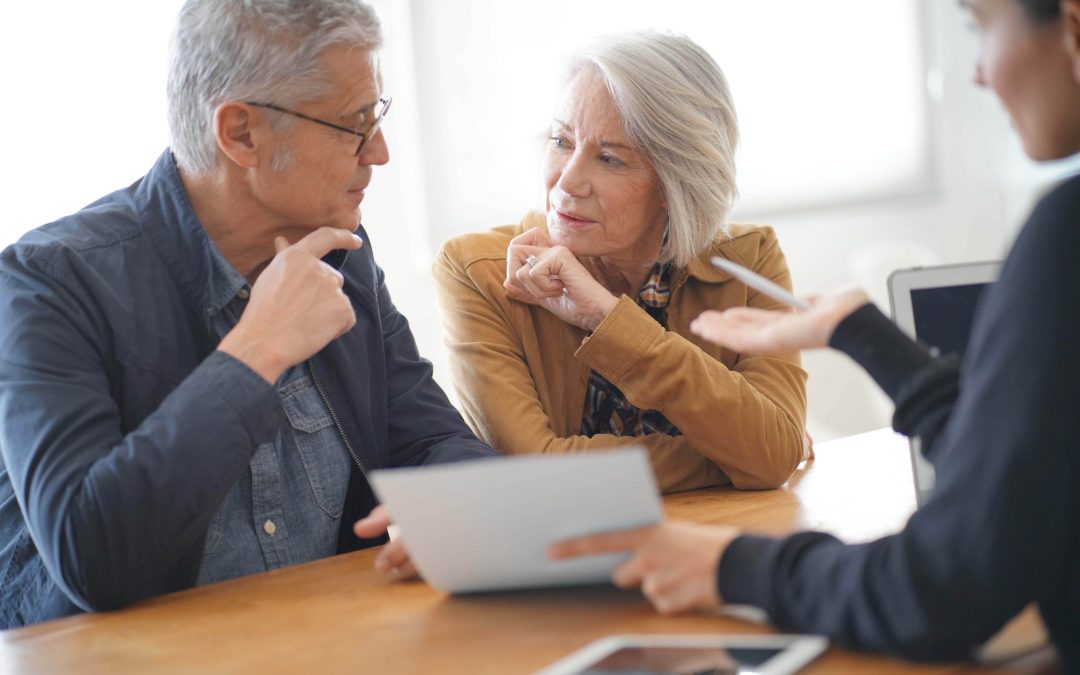 Modern senior couple signing housing contract